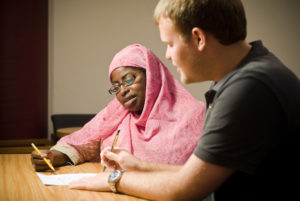 Samaa Abdurraqib (left), an instructor at the University of Wisconsin-Madison writing center, provides help to a student on July 16, 2008. Photo by: Bryce Richter 